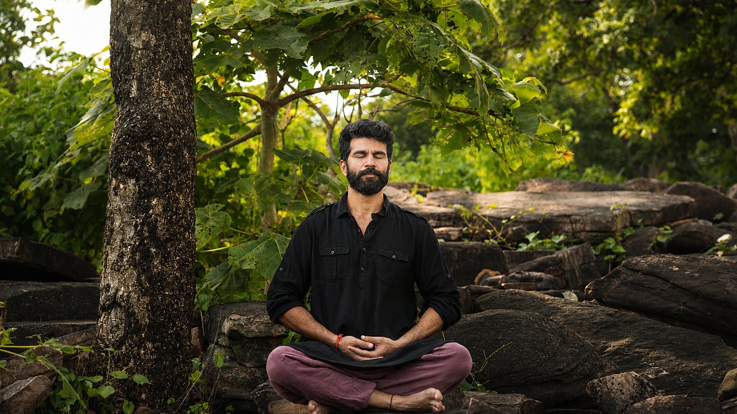 Meditating on the rocks in the forest