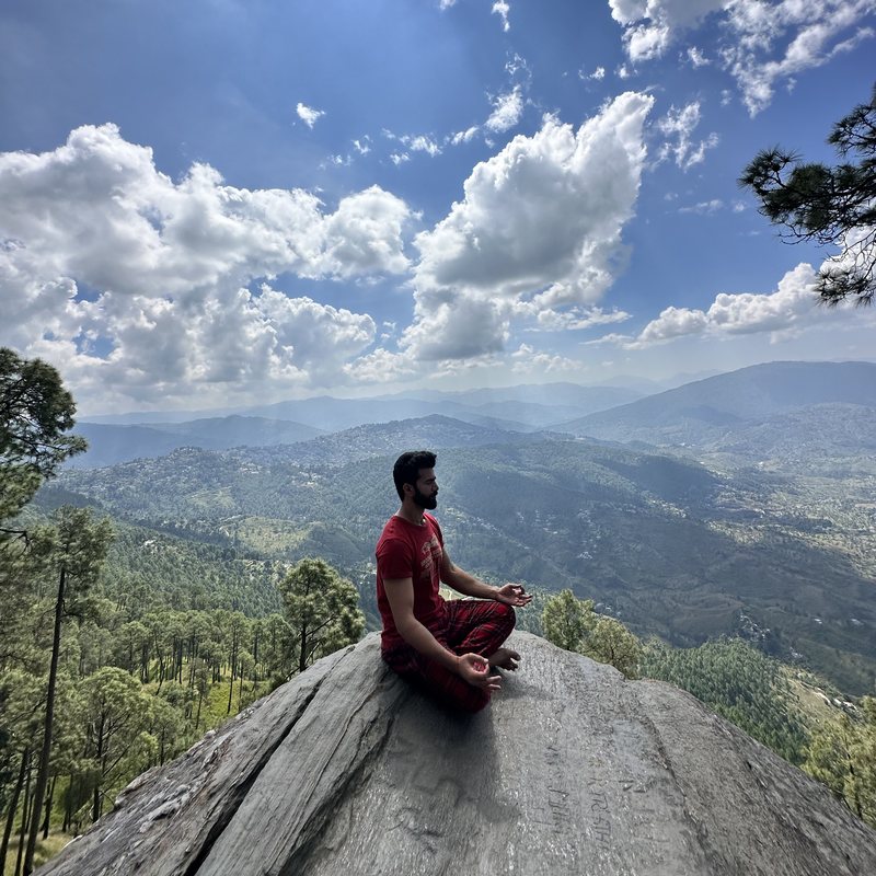 Nived sitting on the rock above the valley at Kasar